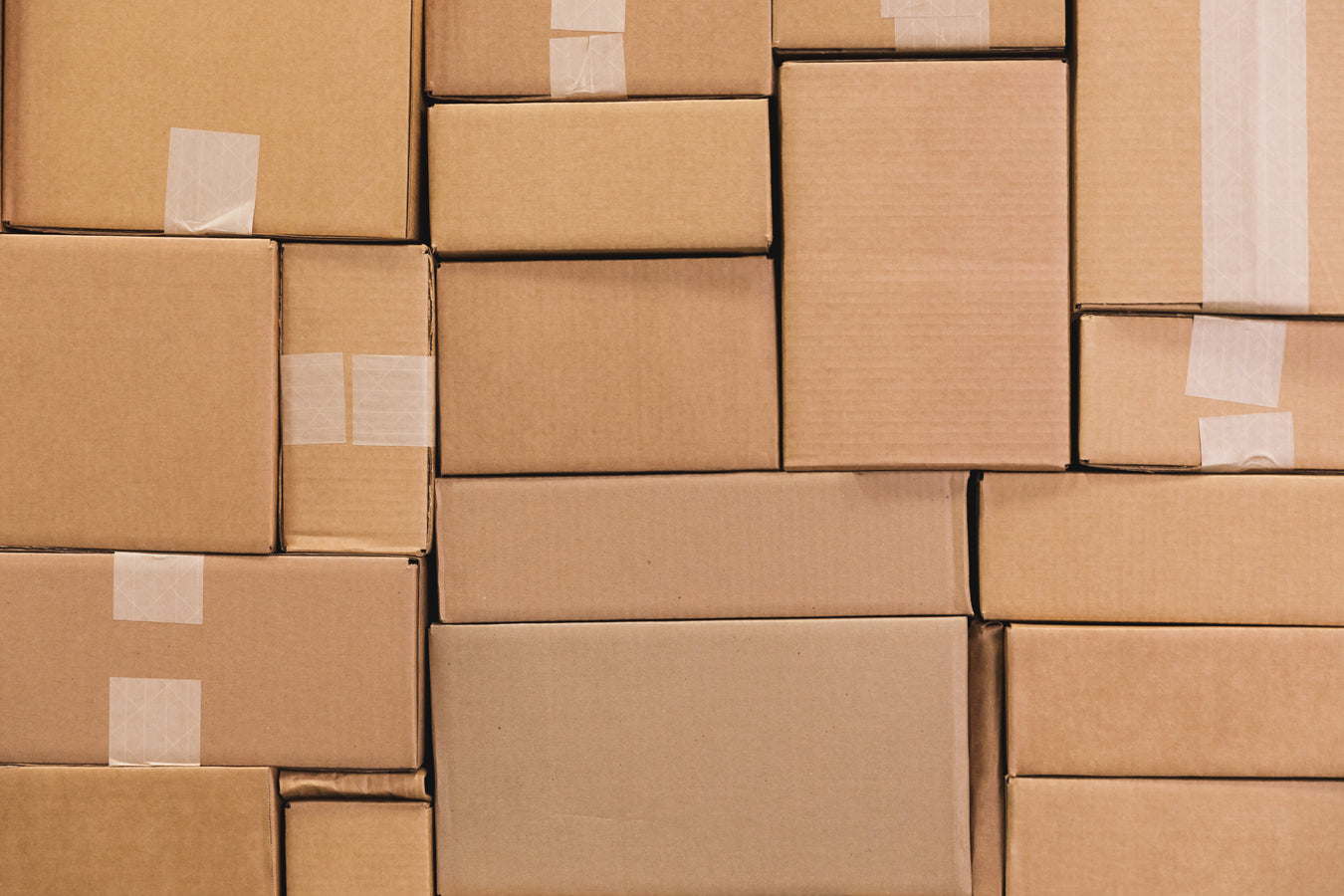 Mostly greyed-out picture of cardboard boxes stacked Tetris-style