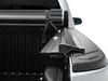 Back view of truck with open tonneau cover. Rails sit against truck bed. 