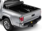 Rear corner view of truck with fully rolled up tonneau cover. 