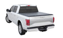 A white truck displaying a black roll-up Tonneau cover from TonnoSport, emphasizing its utility and style.