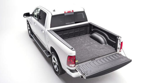 A pickup truck equipped with a black roll-up tonneau cover by Access Vanish.