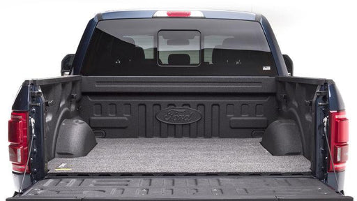 Back of a truck featuring a gray BedRug Classic Bed Mat, providing a soft surface for cargo protection.